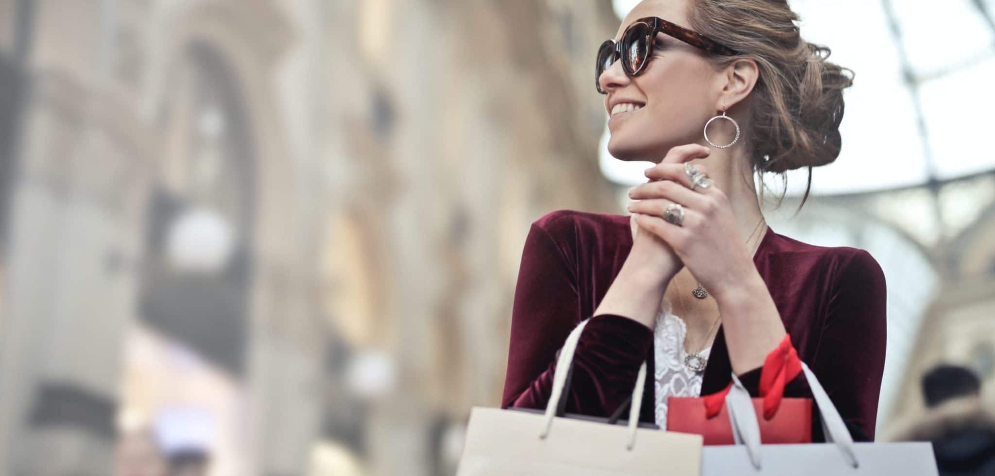 woman holding two white and beige shopping paper bags in 974911 scaled e1587143374681