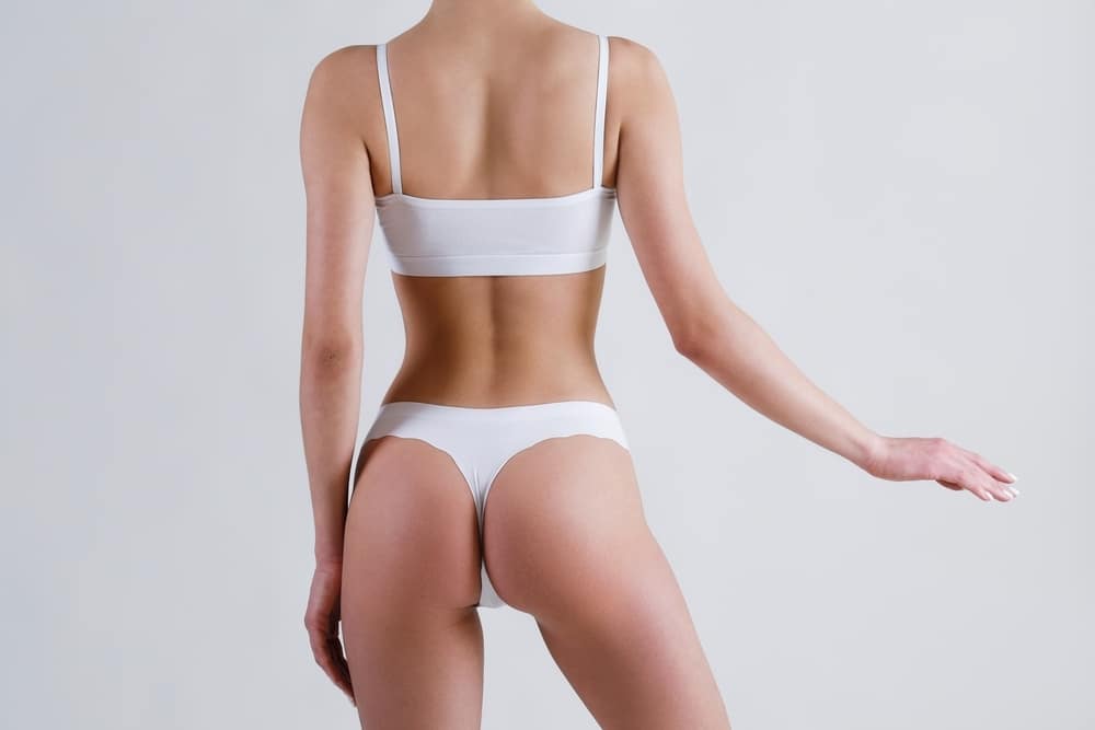 A woman posing in white underwear after lower body rejuvenation in Hauppauge, NY