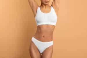 A cropped shot of a woman's torso after a tummy tuck in Hauppauge