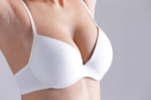 A close-up shot of a woman in a white bra after breast reduction surgery in Long Island