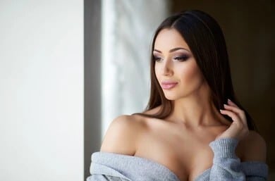 Woman showing the results of Preservé breast augmentation in Long Island