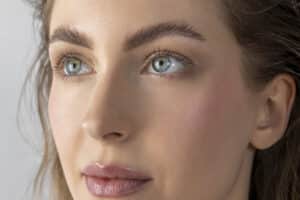 Young woman showing natural-looking results after rhinoplasty.